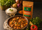 Bowl of chicken curry with Bab Al Hara Chicken Seasoning packet on a table with ingredients.